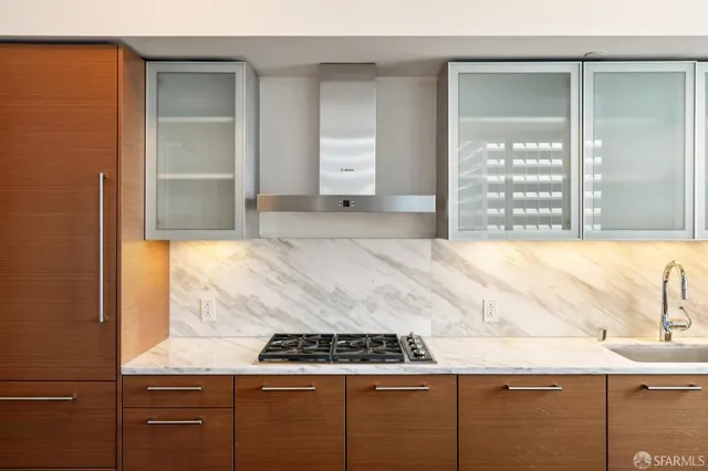 a kitchen with granite countertop a sink and a stove