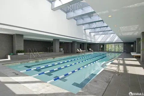 a backyard of a house with barbeque oven table and chairs