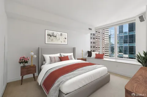 a spacious bedroom with a bed and a window