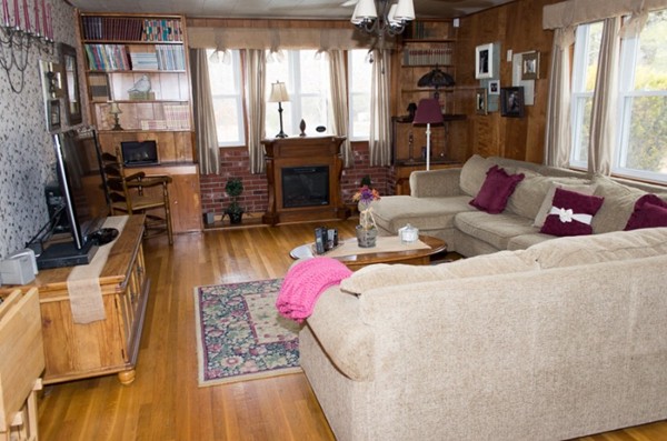 103 Chipaway Road Freetown, MA 02717 - Photo 9 of 26 a living room with furniture a flat screen tv and a floor to ceiling window