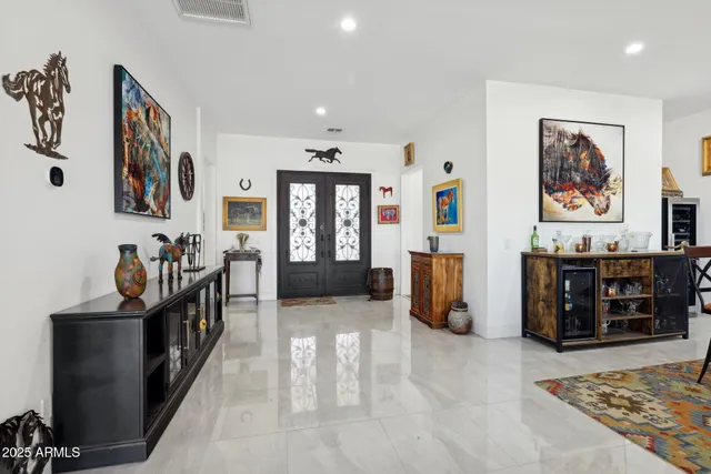 a living room with furniture and kitchen view