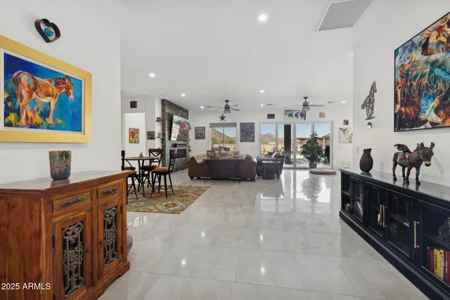 a living room with furniture a flat screen tv and a table