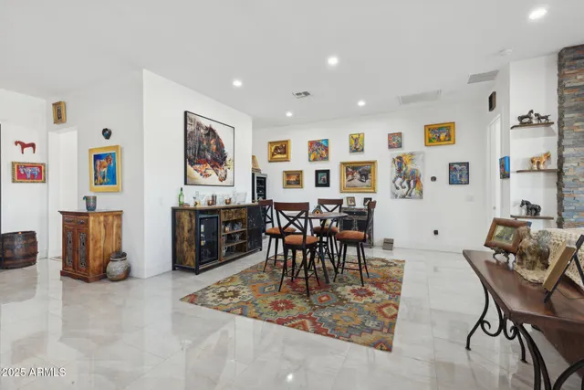 a living room with furniture a flat screen tv and a table