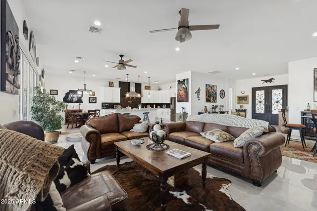 a kitchen with stainless steel appliances granite countertop a sink a stove and a wooden floors