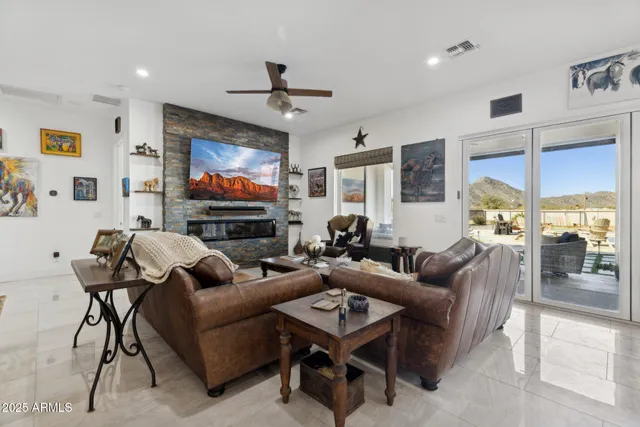 a living room with furniture a piano and a flat screen tv