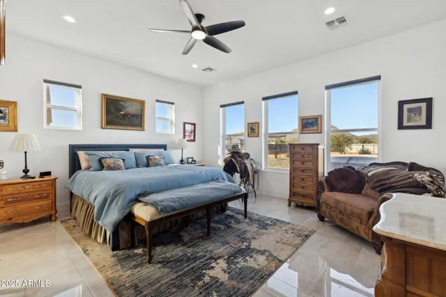 a view of swimming pool that has lawn chairs with wooden floor