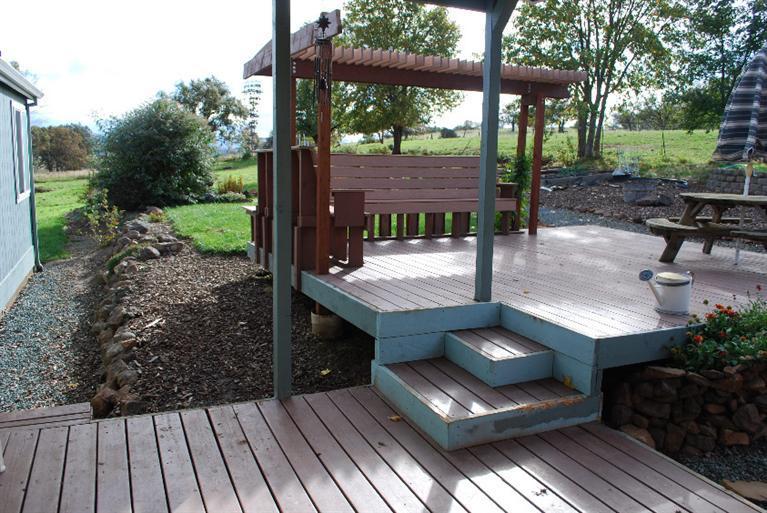1500 Ball Road Eagle Point, OR 97524 - Photo 29 of 35 a view of a patio with table and chairs barbeque grill and wooden fence