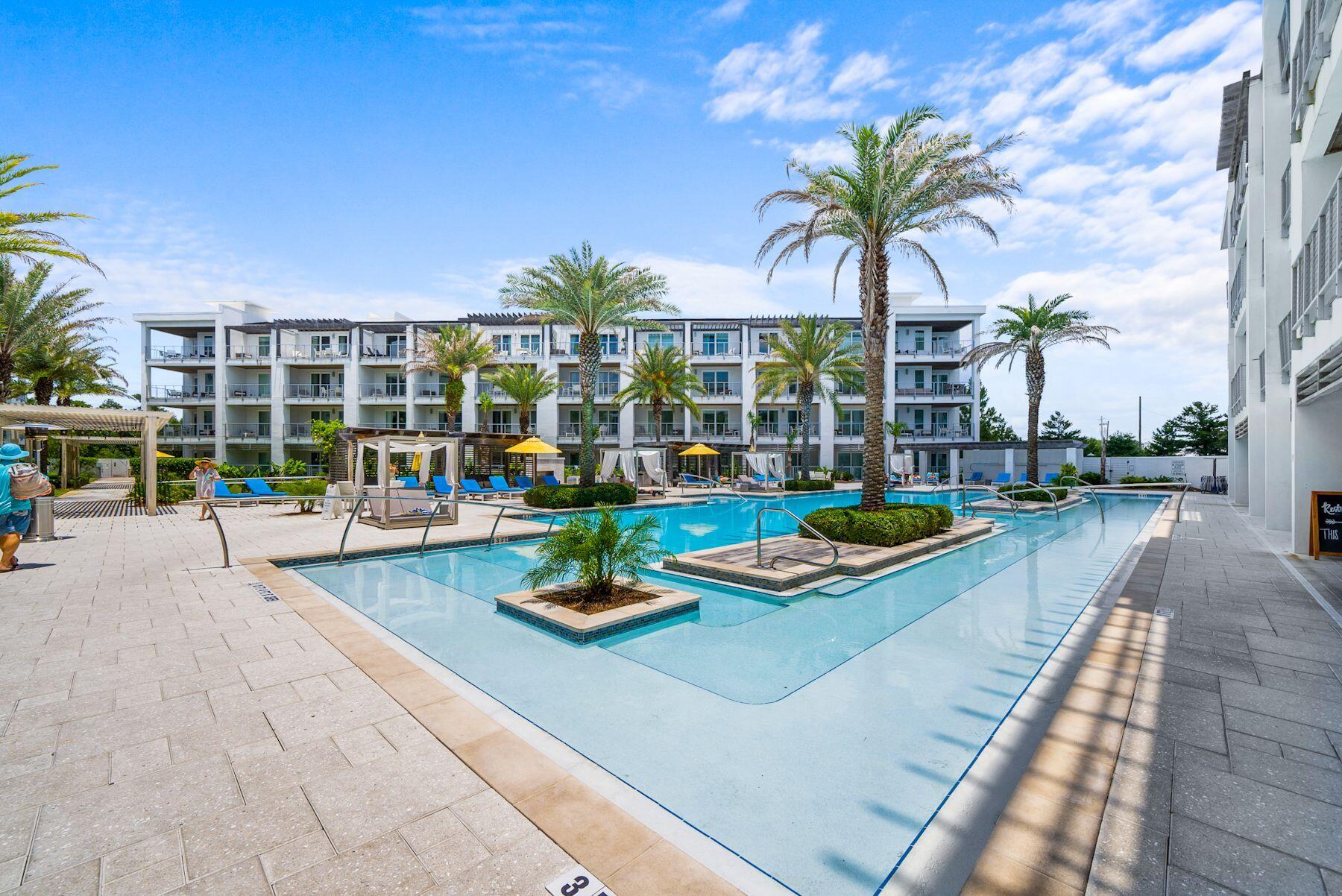 a view of a house with swimming pool and sitting area