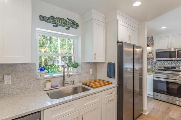 a kitchen with a refrigerator and a sink