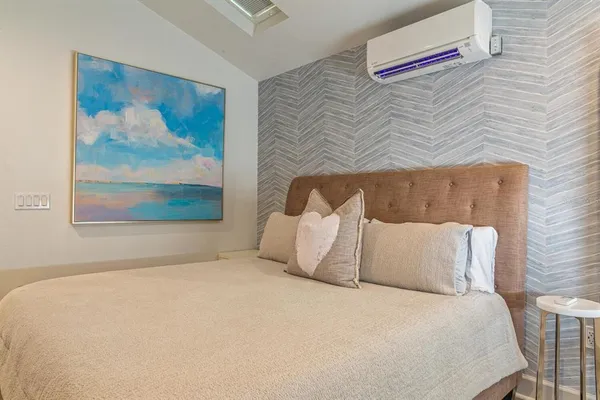 a large bed sitting in a bedroom next to a wall