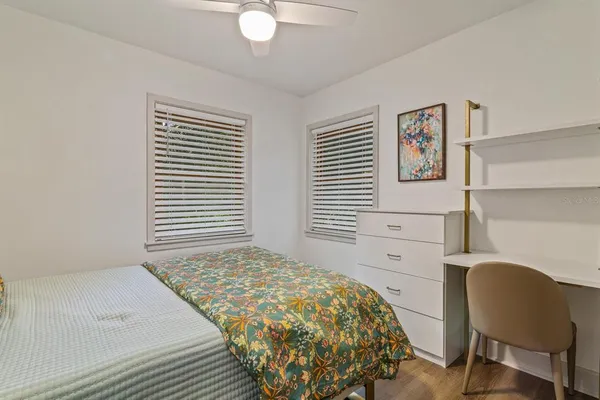 a bedroom with a bed and a chair