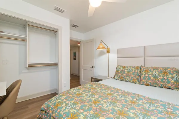 a bedroom with a bed and a chair