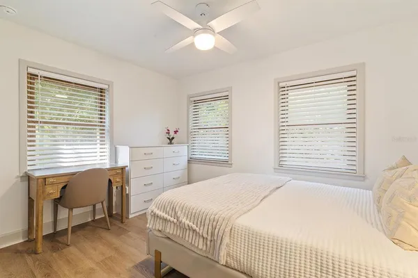 a bedroom with a bed and a table with chair