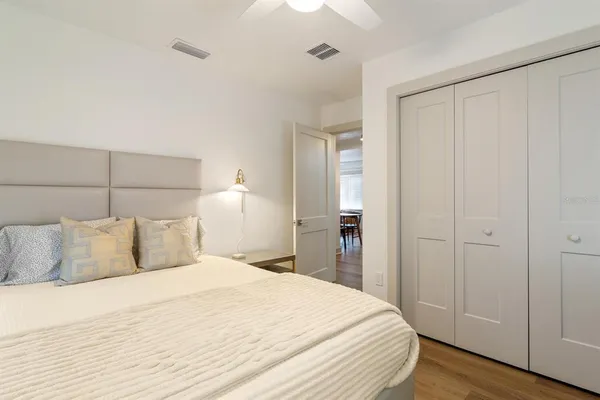 a bedroom with a bed and wooden floor