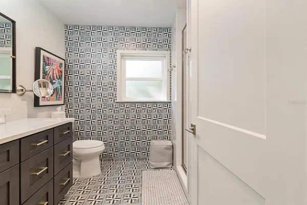 a bathroom with a toilet a sink and shower