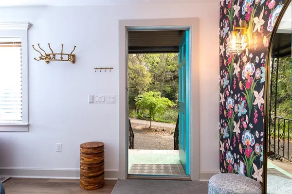 a view of entryway with paintings on the wall
