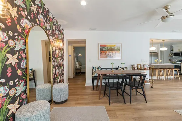 a dining room with furniture and wooden floor