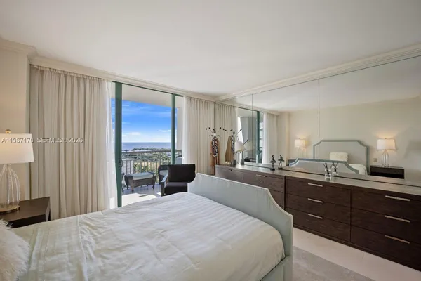 a large bedroom with a large bed and a large window