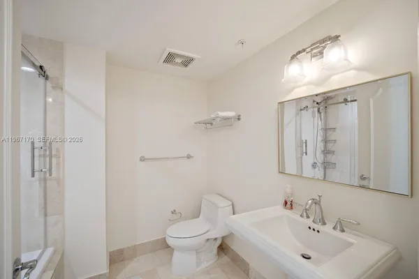 a bathroom with a toilet sink and shower