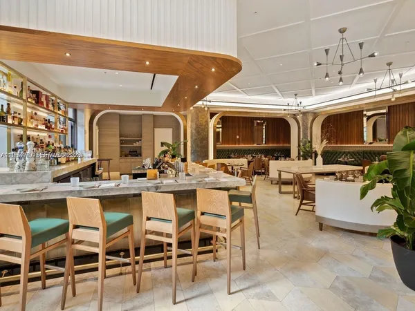 a view of a dining hall with many windows