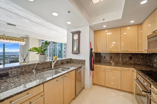 a kitchen with granite countertop sink and cabinets