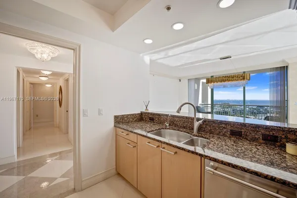 a kitchen with granite countertop a sink and a counter top space