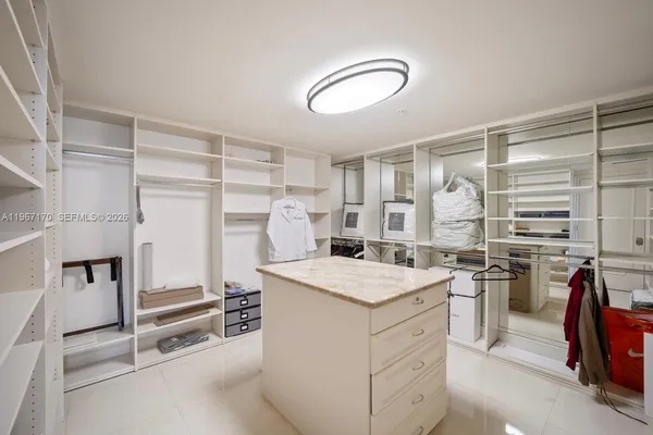 a kitchen that has a lot of cabinets in it and wooden floor