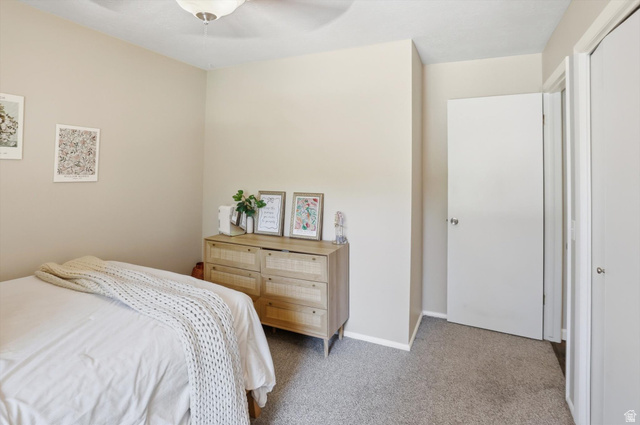8938 Manchester Lane Sandy, UT 84093 - Photo 19 of 50 Carpeted room featuring neutral-toned walls, a ceiling fan with integrated lighting, and white paneled doors