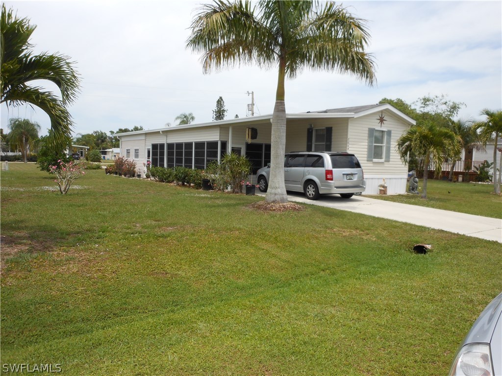 7664 Helen Road Bokeelia, FL 33922 - Photo 1 of 17 a front view of house with yard and seating area