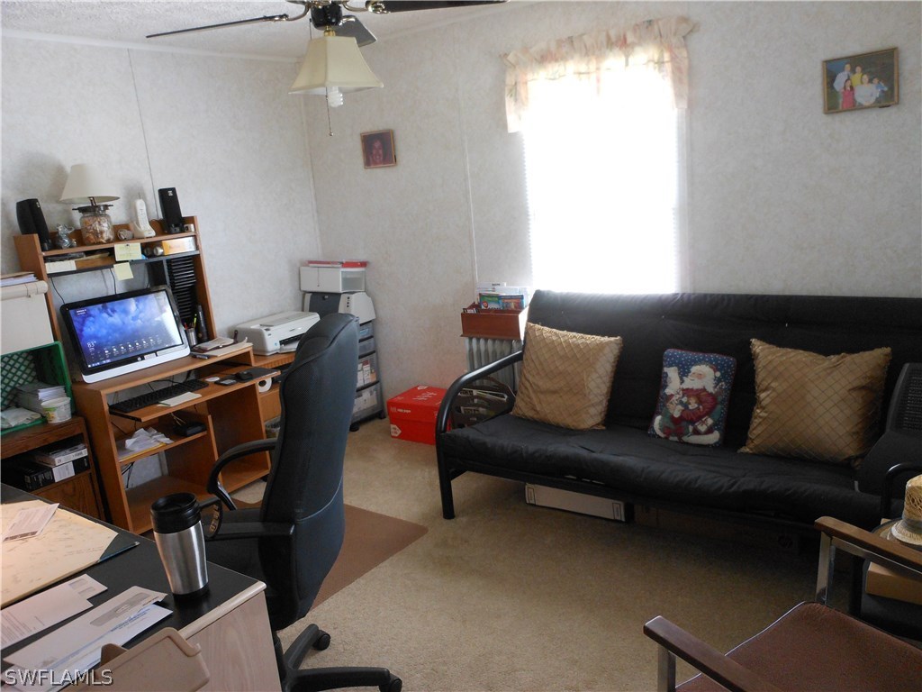 7664 Helen Road Bokeelia, FL 33922 - Photo 11 of 17 a living room with furniture a air conditioner and a window