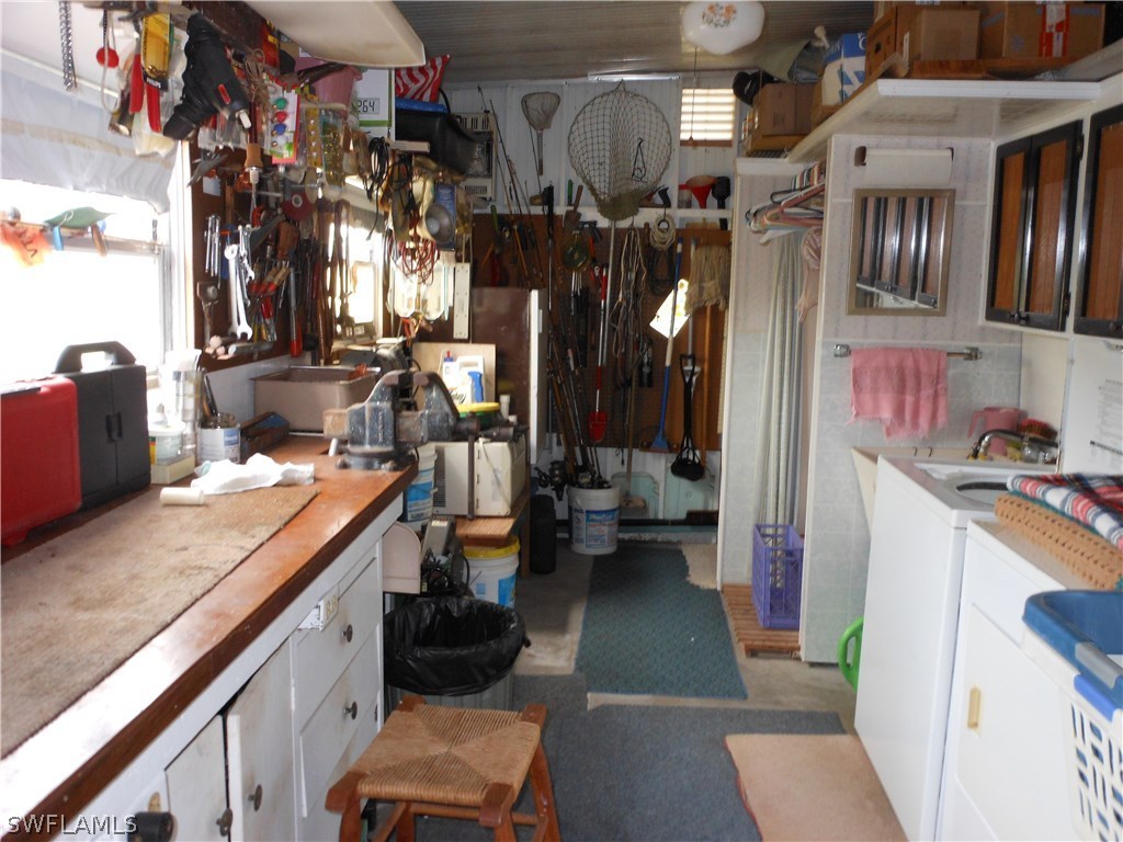 7664 Helen Road Bokeelia, FL 33922 - Photo 12 of 17 a storage room with washer and dryer