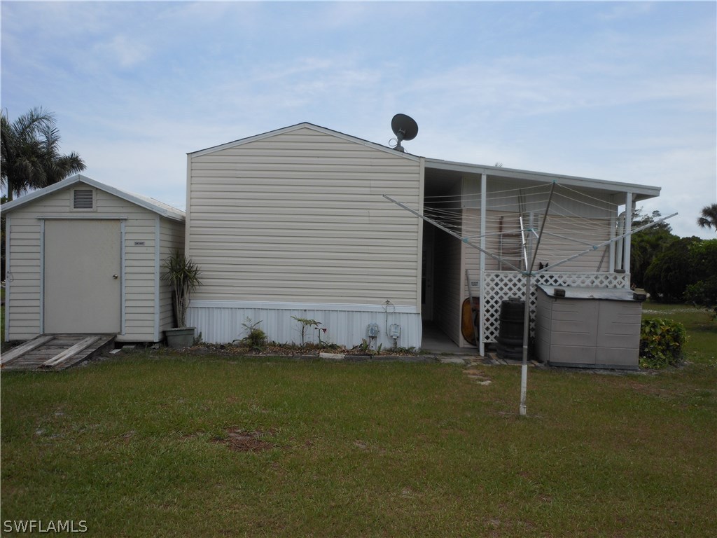 7664 Helen Road Bokeelia, FL 33922 - Photo 16 of 17 a front view of a house with a yard