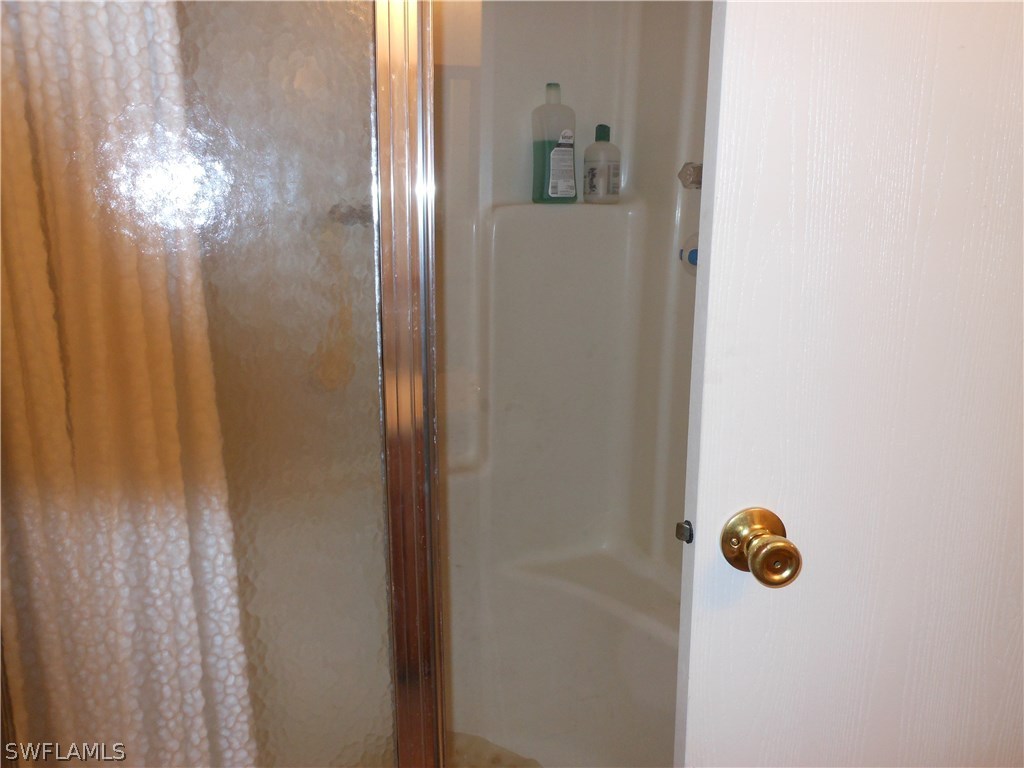 7664 Helen Road Bokeelia, FL 33922 - Photo 10 of 17 a bathroom with a shower