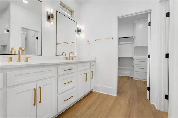 a bathroom with a double vanity sink and mirror