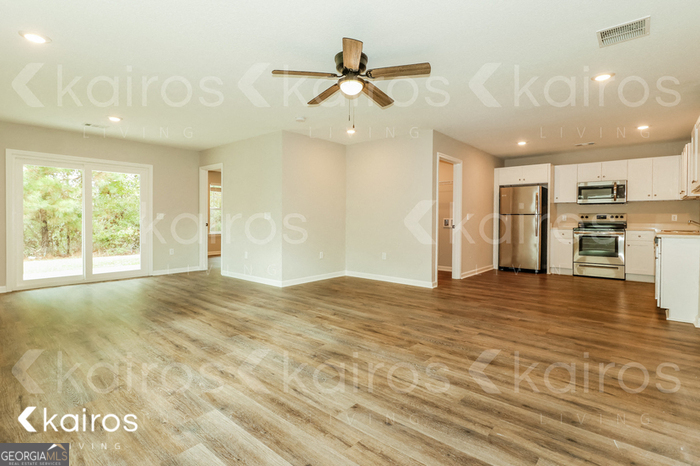 126 Cottage Grove Road Brunswick, GA 31525 - Photo 7 of 17 a view of an empty room with kitchen and a window