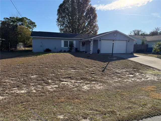 a view of a house with a yard and garage