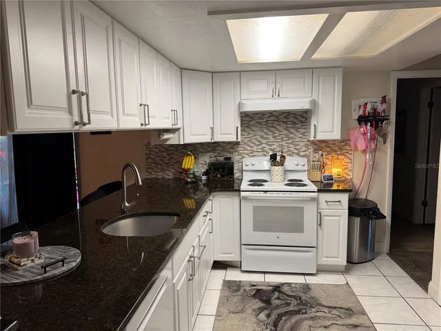 a kitchen with a sink stove and refrigerator
