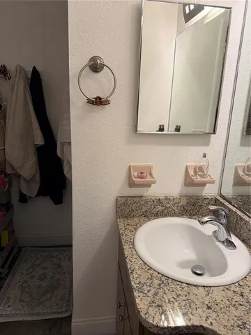a bathroom with a sink and mirror