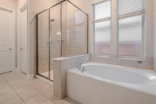 a spacious bathroom with a bathtub and shower