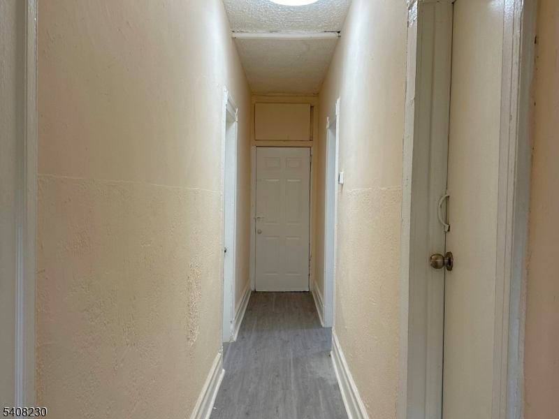 276 Atlantic Street, Unit 2 Paterson, NJ 07503 - Photo 6 of 6 a view of a hallway with wooden floor