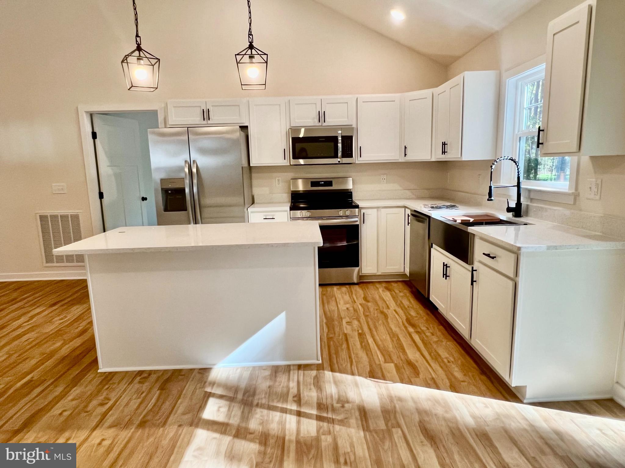 73 Azalea Way Colonial Beach, VA 22443 - Photo 4 of 13 a large kitchen with stainless steel appliances granite countertop a stove a sink dishwasher and a refrigerator