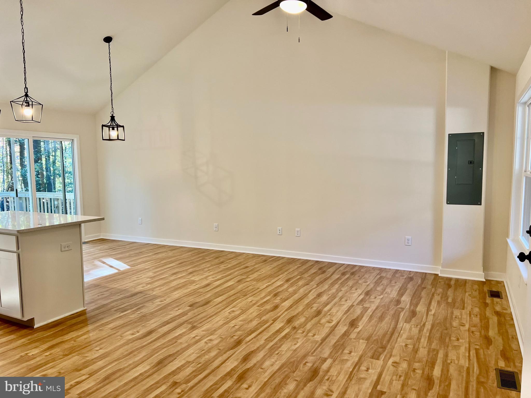 73 Azalea Way Colonial Beach, VA 22443 - Photo 7 of 13 a view of an empty room with wooden floor and a window