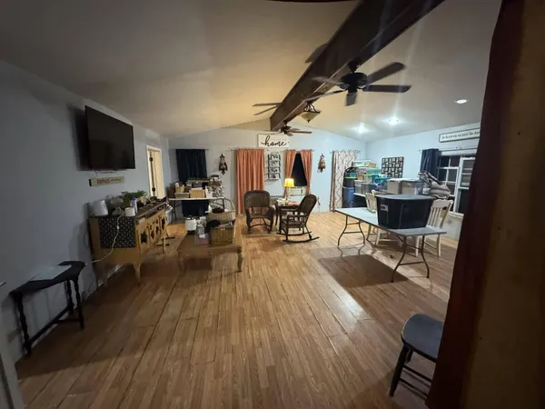 a living room with lots of furniture and a flat screen tv