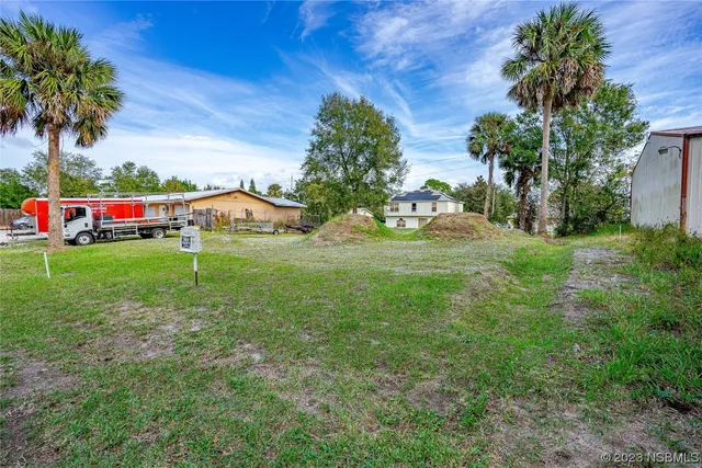 a house with a yard and a large tree