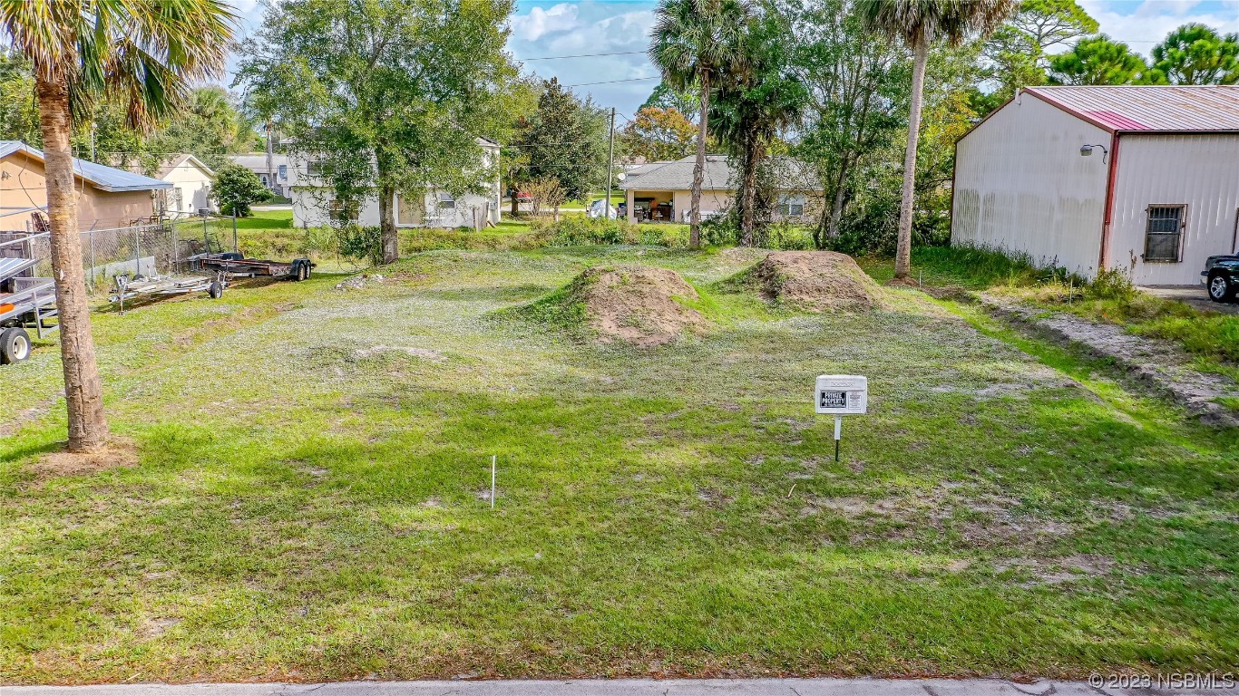 2421 Guava Drive Edgewater, FL 32141 - Photo 8 of 15 a backyard of a house with table and chairs