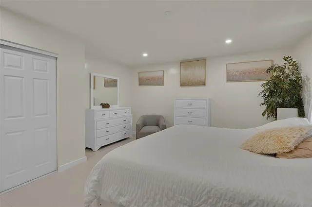 a bedroom with a bed and a couch