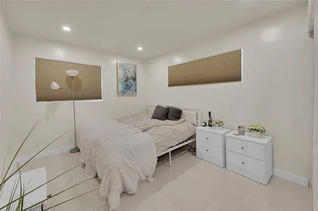 a bed room with a bed and a night stand