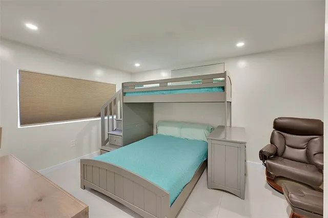 a bedroom with a bed and chair