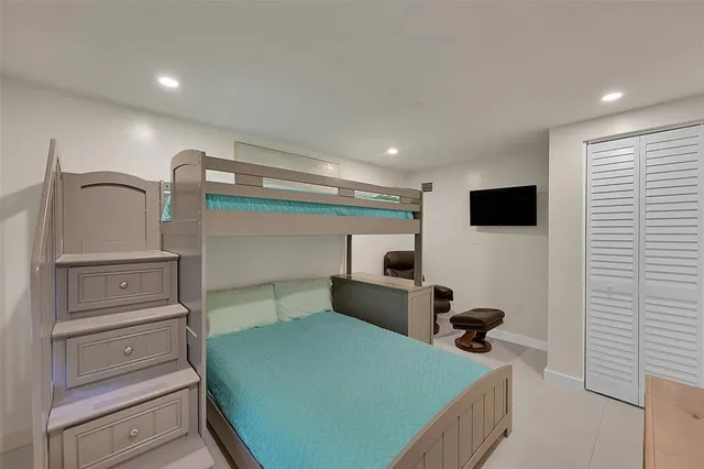 a bedroom with a bed and a flat tv screen