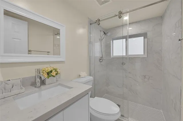 a bathroom with a sink toilet and shower